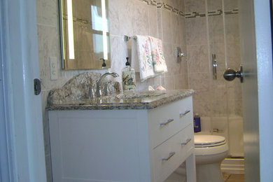 Inspiration for a mid-sized master multicolored tile and porcelain tile porcelain tile alcove shower remodel in New York with open cabinets, white cabinets, a two-piece toilet, an undermount sink and quartz countertops