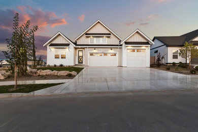 Example of a mid-sized farmhouse gray two-story mixed siding house exterior design in Boise with a hip roof and a mixed material roof