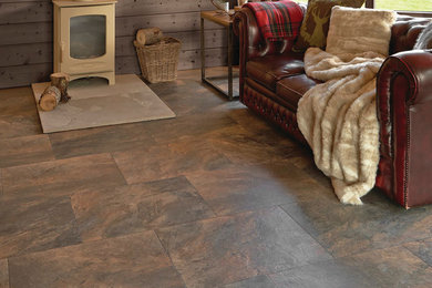 Example of a mid-sized classic formal and enclosed slate floor and brown floor living room design in New York with brown walls, a wood stove, a metal fireplace and no tv
