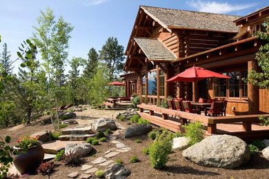 Example of a large mountain style brown two-story wood exterior home design in Other with a shingle roof