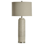 StyleCraft Home Collection - Anastasia ceramic tall table lamp with natural linen shade - This tall antique off-white finish ceramic table lamp uses its large profile and refined detailing to create a distinctive contemporary feel. This standout fixture is made with a cylindrical body that features a ridge motif and round metal base. It's a favorite for lending a sophisticated quality to console tables, entryways, bedroom dressers, and beyond.