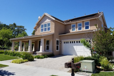 Large modern beige two-story wood exterior home idea in Orange County with a shingle roof