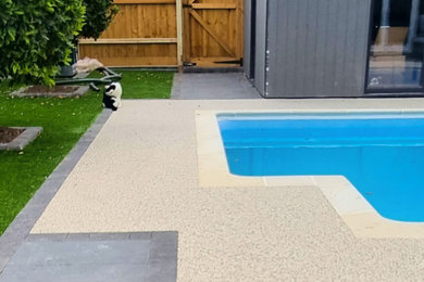 Photo of a small back custom shaped swimming pool in Dorset with with pool landscaping and tiled flooring.