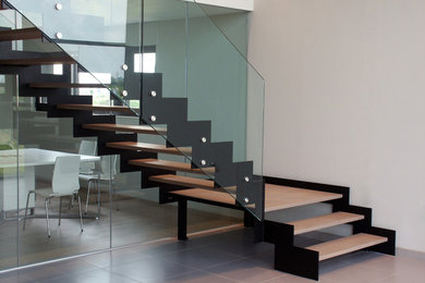 Design ideas for a staircase with glass railing.