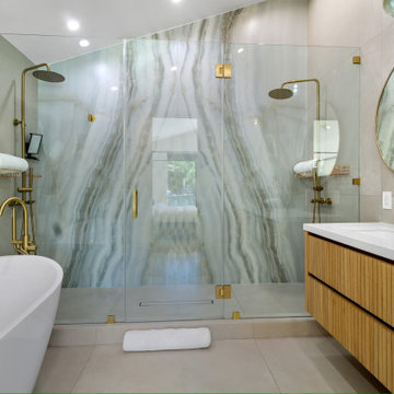 Double Shower and Freestanding Tub Against the Stone Wall