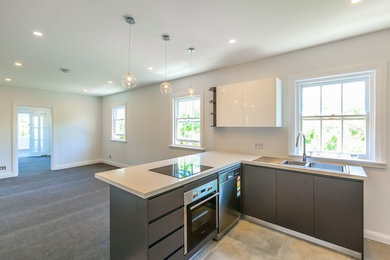 Photo of a small contemporary l-shaped eat-in kitchen in Sydney with grey cabinets, quartz benchtops, white splashback, stone slab splashback, stainless steel appliances and ceramic floors.