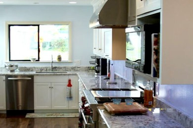 Example of a large transitional l-shaped medium tone wood floor eat-in kitchen design in San Francisco with an undermount sink, shaker cabinets, white cabinets, granite countertops, stainless steel appliances and an island
