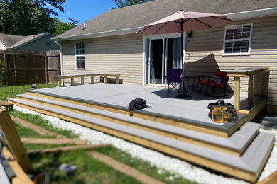 Inspiration for a large contemporary backyard deck skirting remodel in Other with no cover