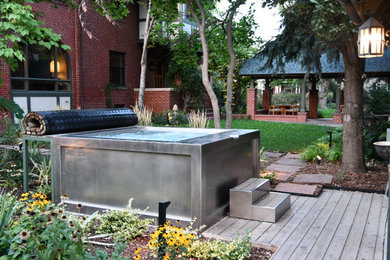 Example of a large transitional backyard rectangular aboveground pool design in Denver with decking