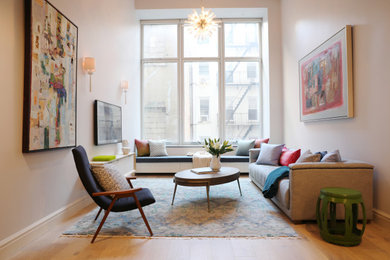 Mid-sized trendy loft-style light wood floor and gray floor living room photo in New York with gray walls and a wall-mounted tv
