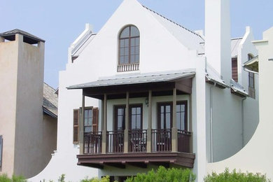 Mid-sized tuscan white two-story stucco gable roof photo in Miami