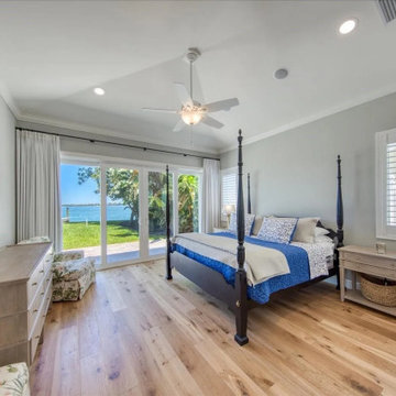 Coastal Master Bedroom with Panoramic Waterfront Views and Private Pool Access