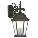 Livex Lighting - Outdoor Wall Lantern With Clear Water Glass, Textured Black - A decorative top and arm are paired with a simple six-sided frame in this textured black and clear water glass outdoor wall lantern is constructed of cast aluminum.