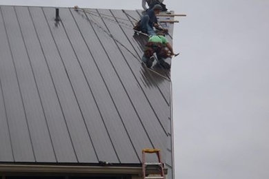 Transitional house exterior idea in Detroit with a metal roof