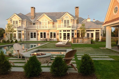Beach style patio photo in Boston with a fire pit
