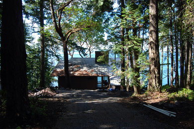 Example of a mid-sized trendy gray two-story wood exterior home design in Seattle