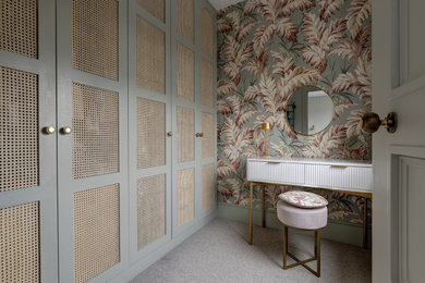 Traditional dressing room for women in London with recessed-panel cabinets and grey cabinets.