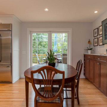 Modern Kitchen with White Flat Panel Shaker Cabinets & Natural Stone Backsplash