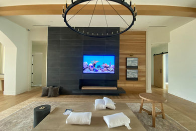 Large trendy open concept beige floor and exposed beam living room photo in Tampa with beige walls, no fireplace and a media wall