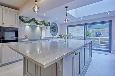 Inspiration for a large modern open plan kitchen in Other with shaker cabinets, grey cabinets, quartz worktops, grey splashback, an island, grey floors and grey worktops.