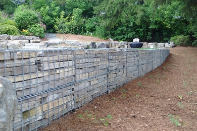 Inspiration for a large asian hillside retaining wall landscape in Toronto.