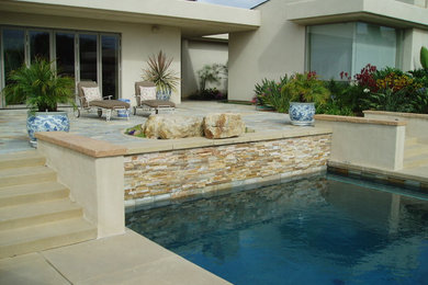 Contemporary backyard patio in San Diego with concrete slab.