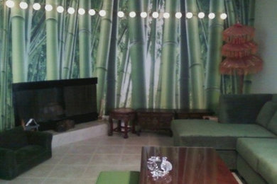 Example of a large island style enclosed living room design in Orange County with green walls and a corner fireplace