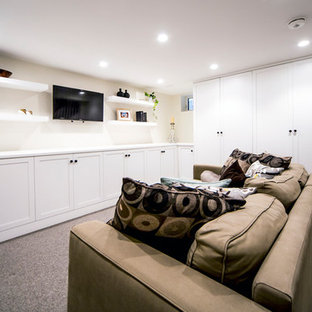 Design ideas for a small traditional look-out basement in Ottawa with beige walls, carpet and grey floors.