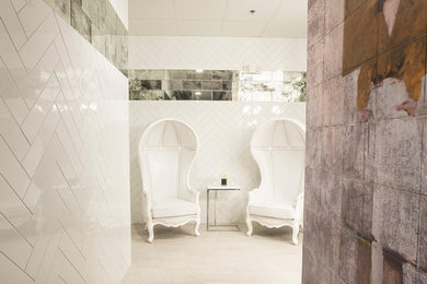 This is an example of a large contemporary bathroom in Chicago with white tile, ceramic tile, ceramic floors and white floor.