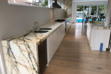 Inspiration for a contemporary kitchen in Sydney with marble benchtops.