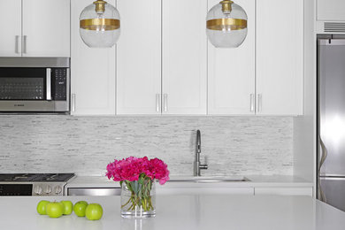 Open concept kitchen - mid-sized modern l-shaped slate floor open concept kitchen idea in New York with an undermount sink, shaker cabinets, white cabinets, quartz countertops, white backsplash, matchstick tile backsplash, stainless steel appliances and an island