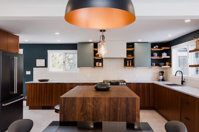 Example of a mid-sized minimalist l-shaped ceramic tile eat-in kitchen design in Other with a drop-in sink, flat-panel cabinets, medium tone wood cabinets, quartzite countertops, white backsplash, subway tile backsplash, black appliances, an island and gray countertops