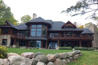Expansive country three-storey brown exterior in Minneapolis with wood siding and a hip roof.