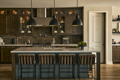 Eat-in kitchen - transitional l-shaped vinyl floor, brown floor and exposed beam eat-in kitchen idea in Los Angeles with a farmhouse sink, shaker cabinets, dark wood cabinets, quartz countertops, multicolored backsplash, brick backsplash, stainless steel appliances, an island and white countertops