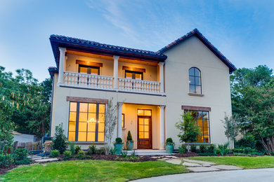 Inspiration for a large mediterranean beige two-story exterior home remodel in Dallas