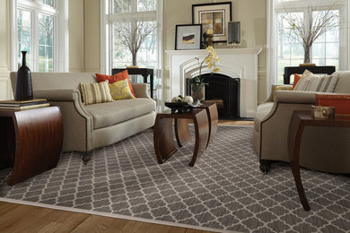 Mid-sized elegant formal and enclosed light wood floor living room photo in Phoenix with beige walls, a standard fireplace and a plaster fireplace