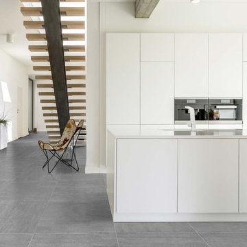 Modern white kitchen with grey porcelain tiled floor