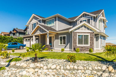 Inspiration for a large transitional gray two-story mixed siding exterior home remodel in Vancouver with a shingle roof