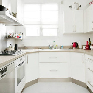 Small modern kitchen pantry designs - Small minimalist u-shaped ceramic floor kitchen pantry photo in Paris with a double-bowl sink, flat-panel cabinets, white cabinets, laminate countertops, white backsplash, stainless steel appliances and no island