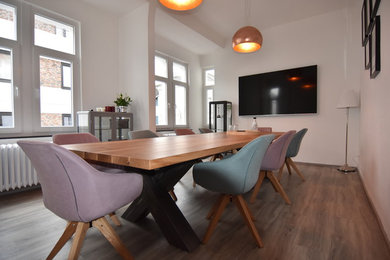 Photo of a mid-sized contemporary separate dining room in Cologne with white walls, medium hardwood floors, no fireplace and brown floor.