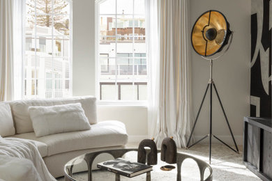 Mid-sized trendy formal and enclosed carpeted and beige floor living room photo in San Francisco with white walls, a ribbon fireplace, a concrete fireplace and a wall-mounted tv