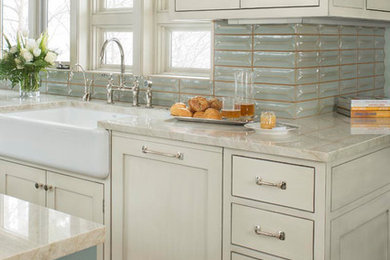 Large country medium tone wood floor and orange floor kitchen photo in Denver with a farmhouse sink, shaker cabinets, white cabinets, quartzite countertops, multicolored backsplash, ceramic backsplash, stainless steel appliances, an island and beige countertops