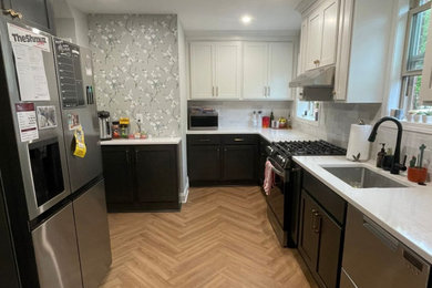Enclosed kitchen - contemporary l-shaped enclosed kitchen idea with an undermount sink, shaker cabinets, white cabinets, quartz countertops, white backsplash, stainless steel appliances, no island and white countertops