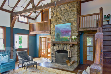 Living room - huge cottage open concept dark wood floor living room idea in San Francisco with blue walls, a standard fireplace and a stone fireplace