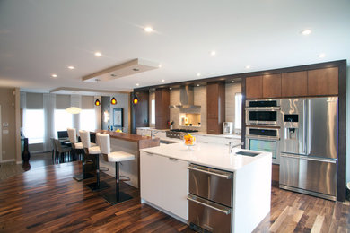 Large minimalist single-wall dark wood floor eat-in kitchen photo in Other with flat-panel cabinets, medium tone wood cabinets, stainless steel appliances, an island, a double-bowl sink, quartz countertops, beige backsplash and porcelain backsplash
