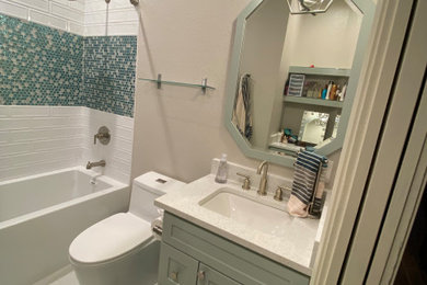 Inspiration for a mid-sized shabby-chic style kids' turquoise tile and glass tile porcelain tile, white floor and single-sink bathroom remodel in Dallas with shaker cabinets, turquoise cabinets, a one-piece toilet, beige walls, an undermount sink, quartz countertops, white countertops, a niche and a built-in vanity