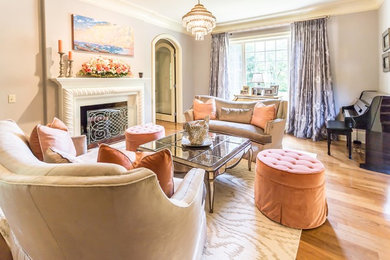 Living room - mid-sized transitional enclosed medium tone wood floor and brown floor living room idea in Philadelphia with gray walls, a standard fireplace, a plaster fireplace and no tv