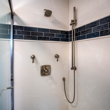 Primary Bathroom with Blue-Gray Vanity and Deep Blue Tiled Feature Wall