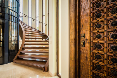Large elegant travertine floor entryway photo in Other with beige walls and a medium wood front door
