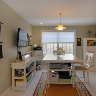 Design ideas for a large modern craft room in Boston with green walls, light hardwood flooring and a freestanding desk.